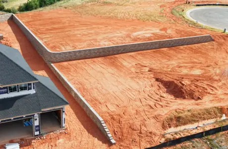 Aerial view of a long retaining wall terracing a sloped homesite